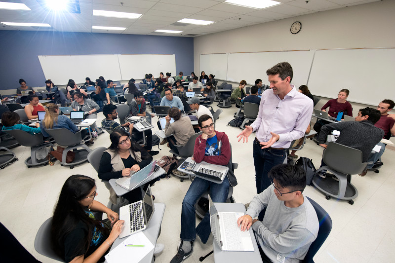 professor teaching students in a multimedia room