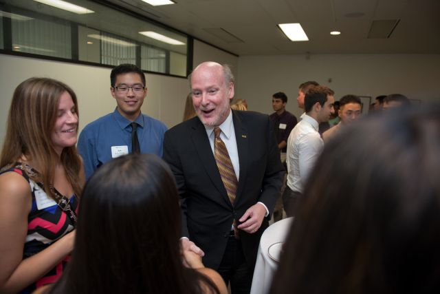 Cancellor Gillman shaking hands in a group